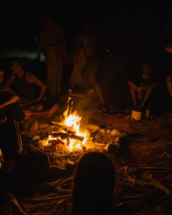 The village gathered in a circle around the fire after dark at Amora, an ecovillage on Costa Rica's South Pacific coast.